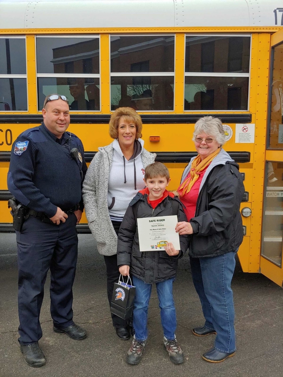 people in front a school bus